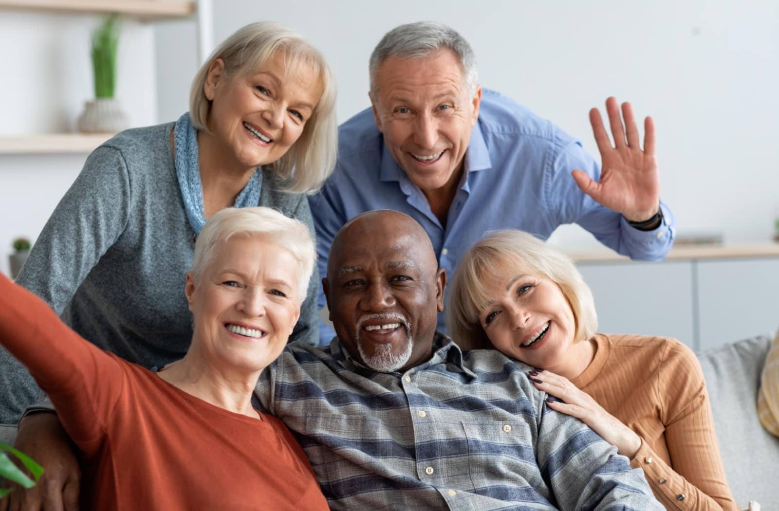 A group of friends smiling in assisted living.