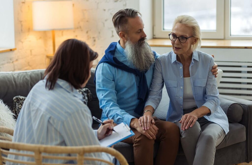 A staff member discusses a mature couple's eligibility for assisted living.